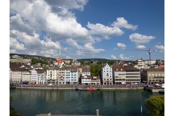 Aufnahme mit Superweitwinkel (20mm) vom Lindenhof in Zürich in Richtung Limmatquai und Niederdorf. Die roten Markierungen zeigen, wohin bei den beiden nachfolgenden Aufnahmen mit maximalem 1200er-Tele gezoomt wurde.